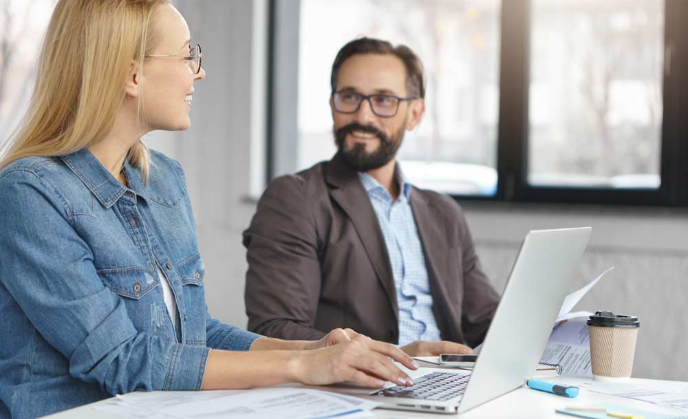 Portrait of female manager and her boss working together in office