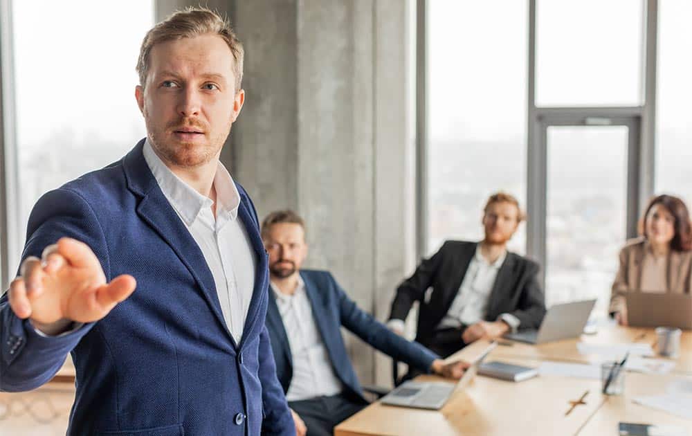 A manager and a team member looking at a project plan together, illustrating the process of delegating a task with clear communication and support.