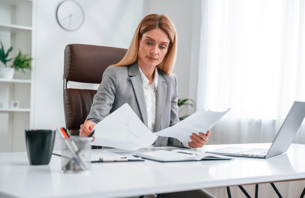 Employer reviewing executive assistant candidate qualifications and preparing interview questions