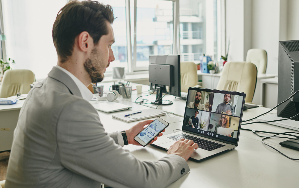 A business leader engaging in a strategic planning session via video call with a professional remote executive assistant.